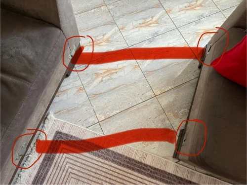 Fauteuil gris en L avec coussins